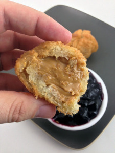 Deep fried peanut butter balls coated in bread and then dipped in jelly